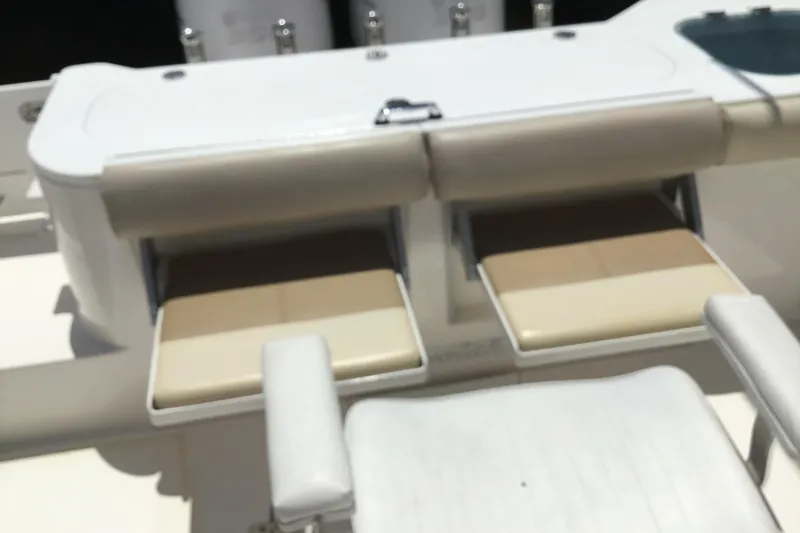Slide: The Image of 2013 Everglades 320EX boat seating area with storage compartments open. - 37
