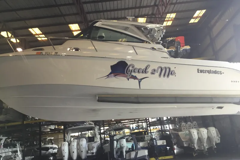 Slide: The Image of 2013 Everglades 320EX boat named "Good 2 Me" in a storage facility. - 60