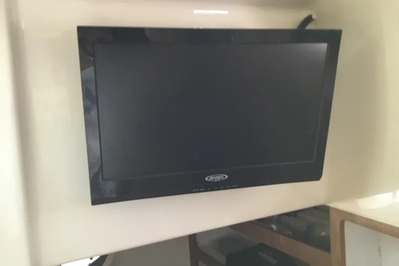 Slide: The Image of Jensen TV mounted inside a 2013 Everglades 320EX boat cabin. - 52