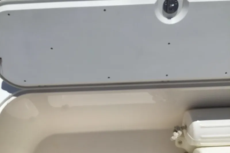 Slide: The Image of Open storage compartment on 2013 Everglades 320EX boat. - 36