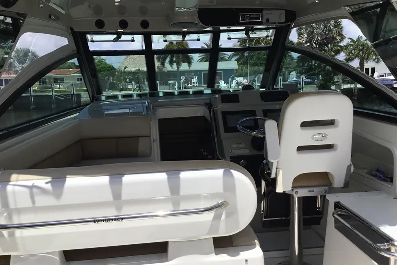Slide: The Image of Interior of a 2013 Everglades 320EX boat, featuring helm and seating area. - 30