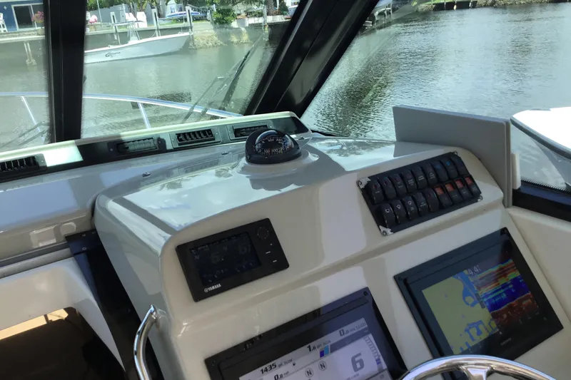 Slide: The Image of Dashboard of a 2013 Everglades 320EX boat with navigation instruments and controls. - 26