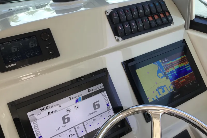 Slide: The Image of Dashboard of a 2013 Everglades 320EX boat with navigation and control displays. - 28