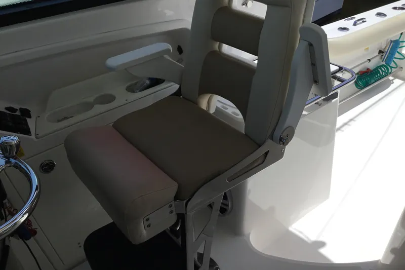 Slide: The Image of Captain's chair on 2013 Everglades 320EX boat, featuring ergonomic design and armrests. - 42