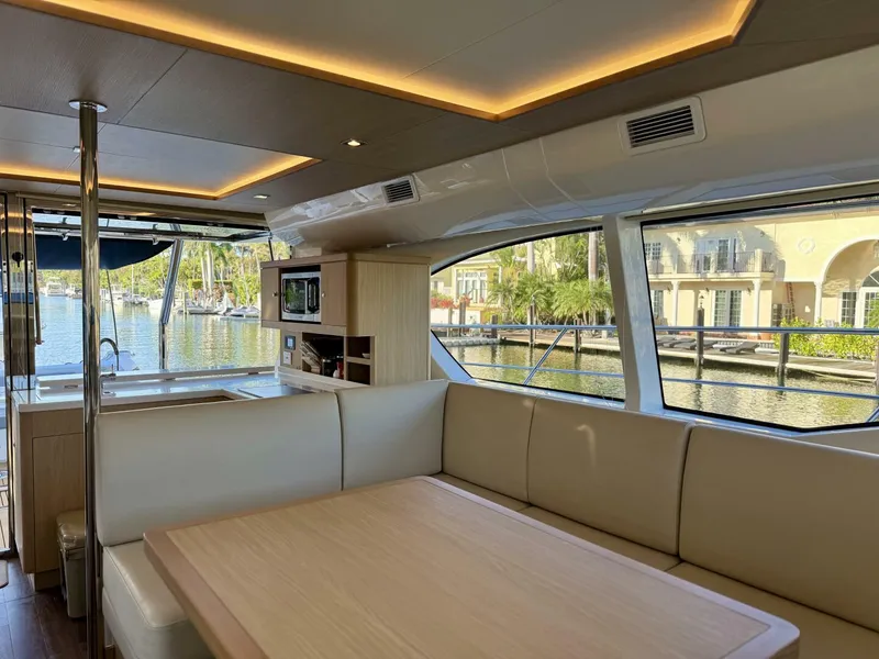 Slide: The Image of Luxurious interior of 2022 Aquila 44 yacht with spacious seating and scenic marina view. - 11