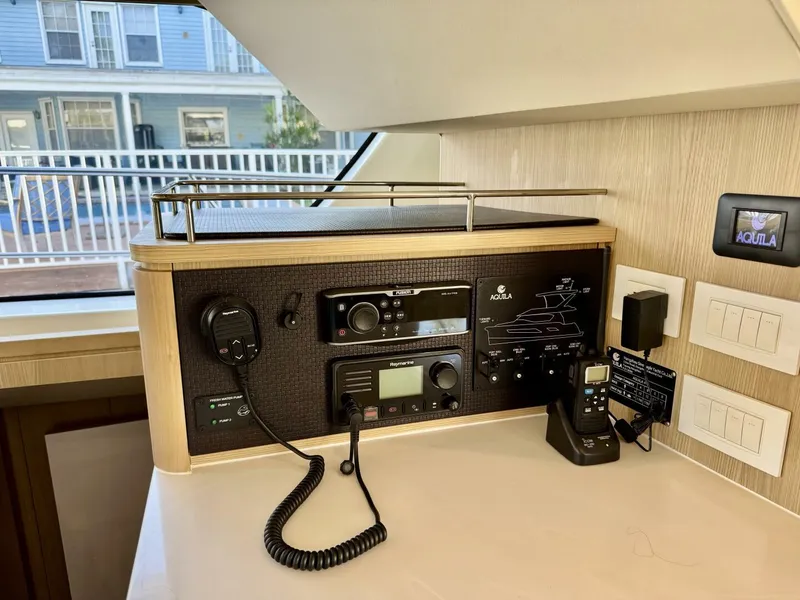 Slide: The Image of Control panel in a 2022 Aquila 44 yacht with communication equipment and switches. - 9