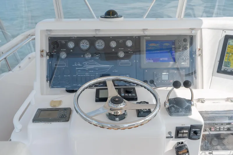Slide: The Image of Cockpit of 2003 Bertram 390 Convertible with navigation instruments and steering wheel. - 14