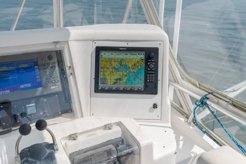 Slide: The Image of Bertram 390 Convertible 2003 boat dashboard with navigation systems and controls. - 15