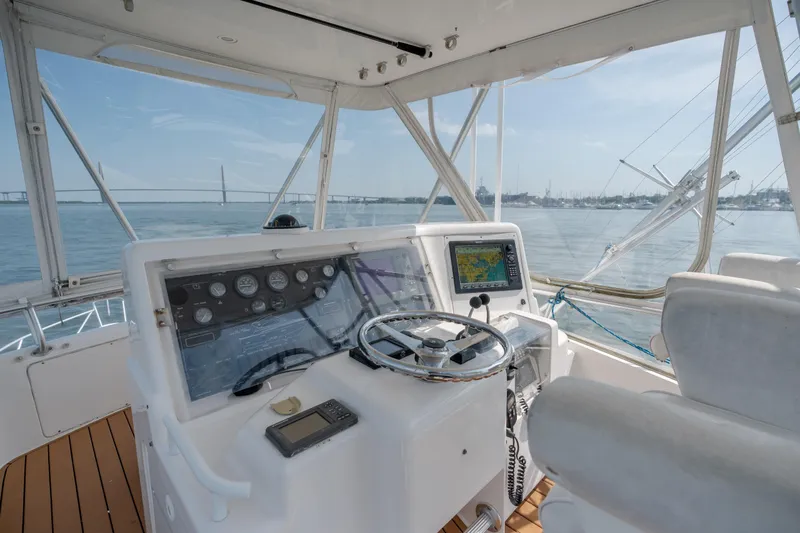 Slide: The Image of Helm of 2003 Bertram 390 Convertible yacht with navigation equipment and ocean view. - 13