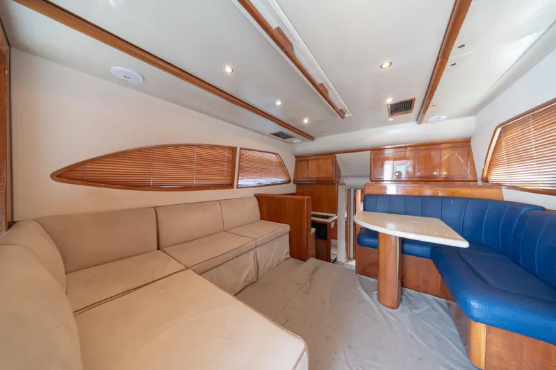 Slide: The Image of Interior of 2003 Bertram 390 Convertible yacht with beige and blue seating. - 23