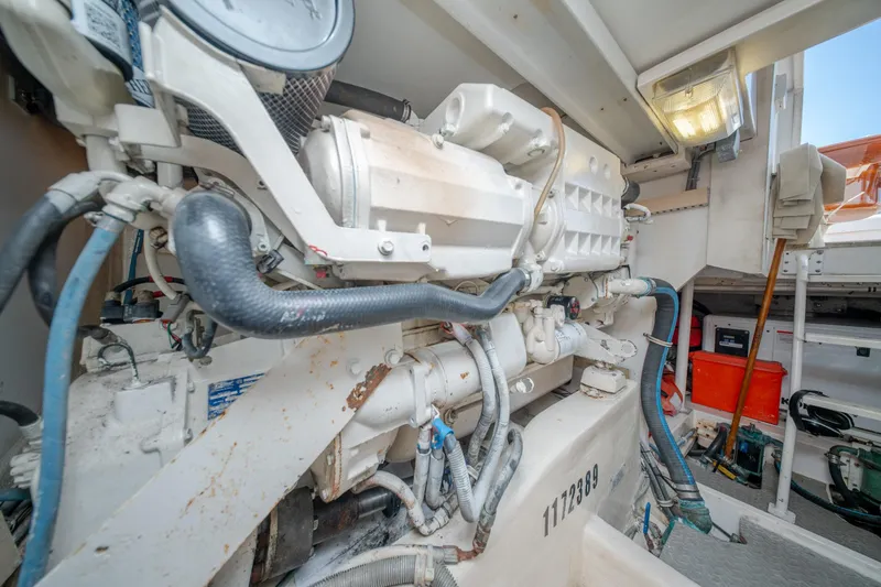 Slide: The Image of Engine room of a 2003 Bertram 390 Convertible yacht, showcasing mechanical components. - 44
