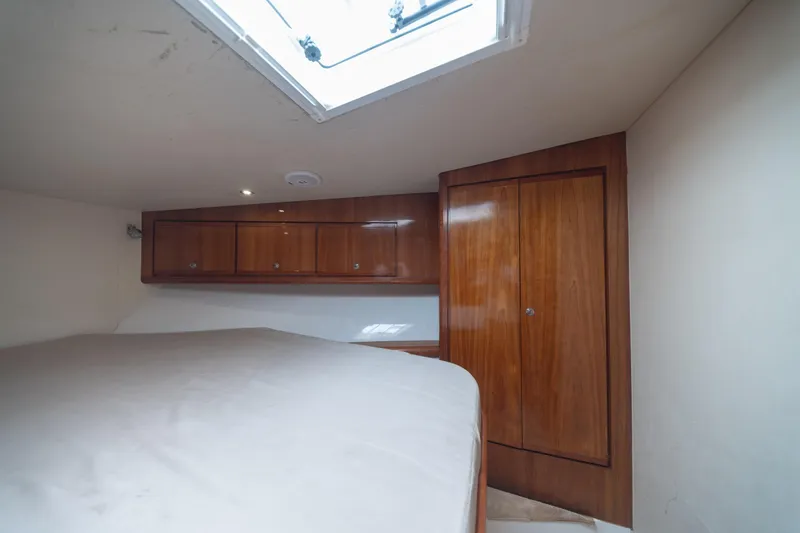 Slide: The Image of Interior cabin of 2003 Bertram 390 Convertible with wooden cabinets and overhead hatch. - 33