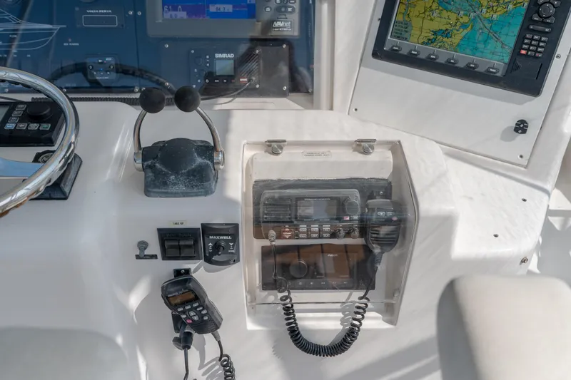 Slide: The Image of Control panel of a 2003 Bertram 390 Convertible boat with navigation equipment. - 16