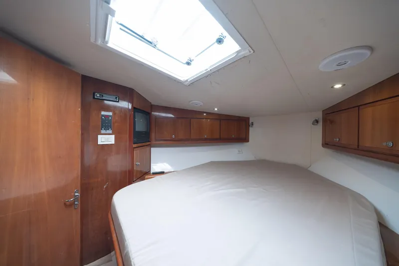 Slide: The Image of Interior cabin of 2003 Bertram 390 Convertible yacht with wood paneling and skylight. - 34