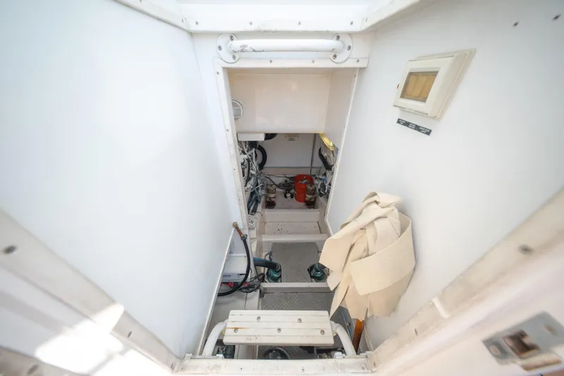 Slide: The Image of Engine room of a 2003 Bertram 390 Convertible boat, featuring equipment and storage. - 39