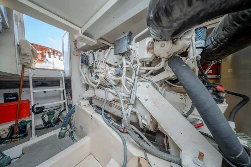 Slide: The Image of Engine room of a 2003 Bertram 390 Convertible yacht, showcasing mechanical components and equipment. - 43