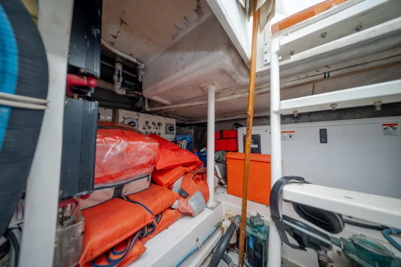 Slide: The Image of Engine room of a 2003 Bertram 390 Convertible with safety equipment and storage. - 46