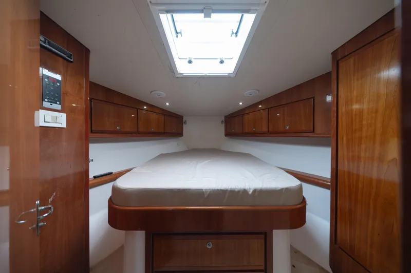 Slide: The Image of Interior cabin of 2003 Bertram 390 Convertible yacht with wooden cabinetry and overhead skylight. - 32
