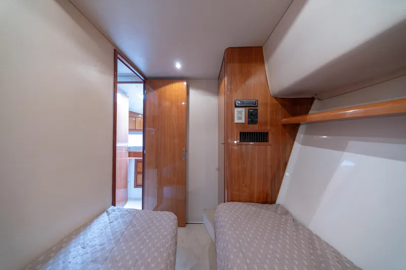 Slide: The Image of Interior cabin of 2003 Bertram 390 Convertible yacht with twin beds and wooden accents. - 36
