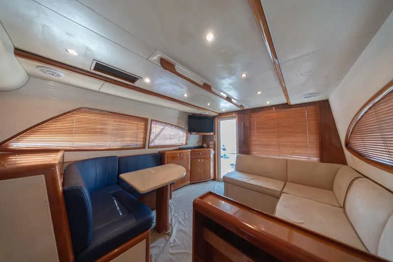 Slide: The Image of Interior of 2003 Bertram 390 Convertible yacht with seating and wooden accents. - 26