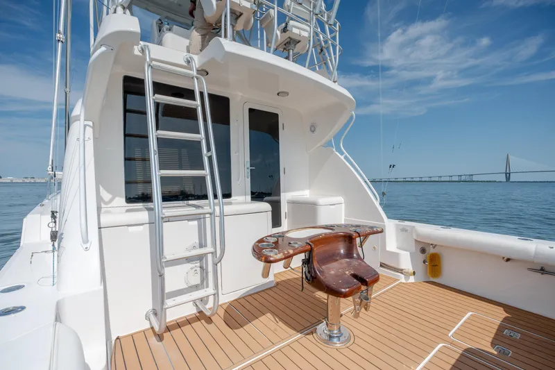 Slide: The Image of 2003 Bertram 390 Convertible yacht deck with fishing chair, ladder, and ocean view. - 52