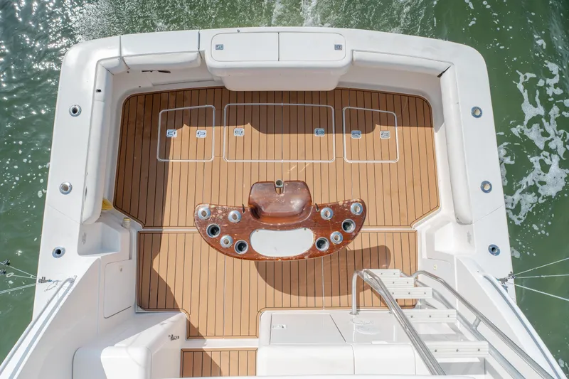 Slide: The Image of Bertram 390 Convertible 2003 boat deck with teak flooring and fishing station. - 56