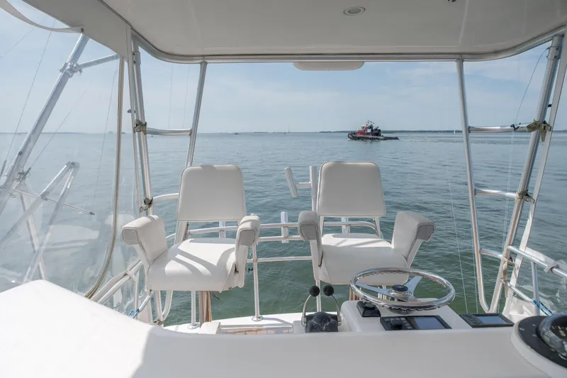 Slide: The Image of Interior view of 2003 Bertram 390 Convertible yacht helm with ocean backdrop. - 21