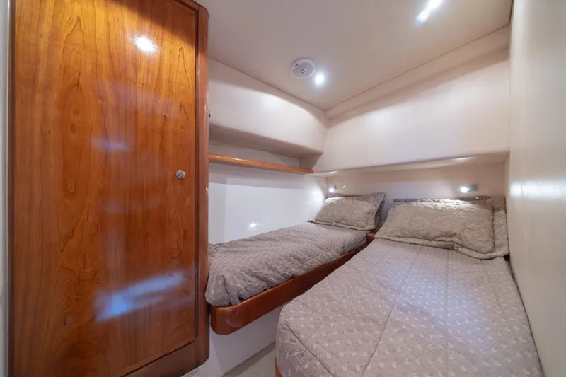 Slide: The Image of Cozy twin cabin in 2003 Bertram 390 Convertible yacht with wooden cabinetry. - 35