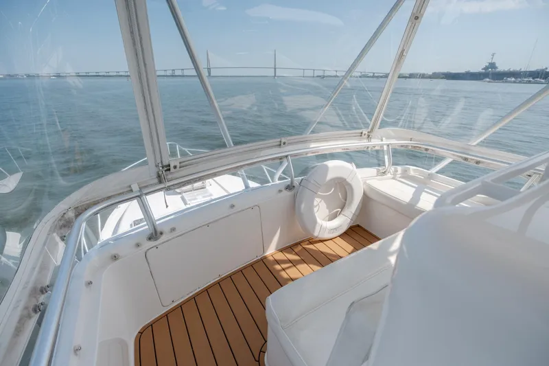 Slide: The Image of 2003 Bertram 390 Convertible yacht interior with wooden deck and panoramic water view. - 18