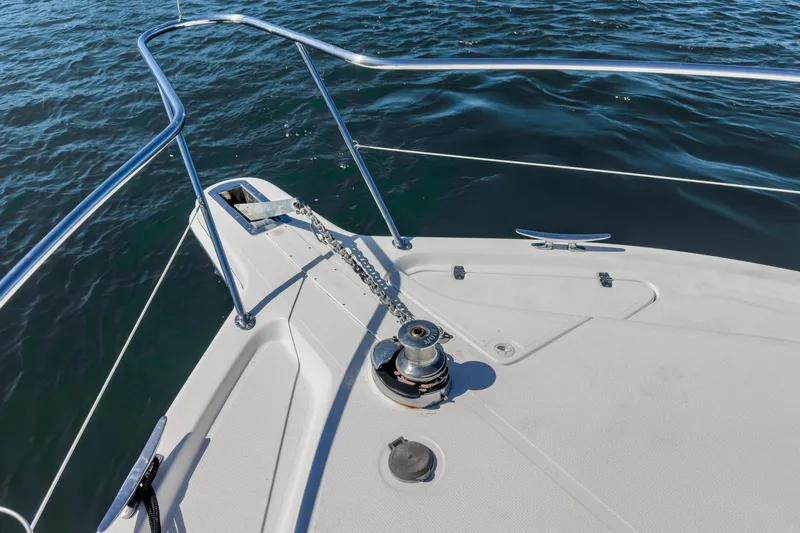 Slide: The Image of Bow of 2006 Riviera 33 Flybridge yacht with anchor chain and railing. - 14