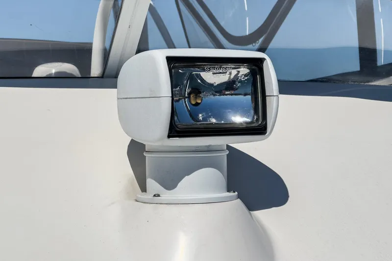 Slide: The Image of Close-up of a spotlight on a 2006 Riviera 33 Flybridge boat. - 20