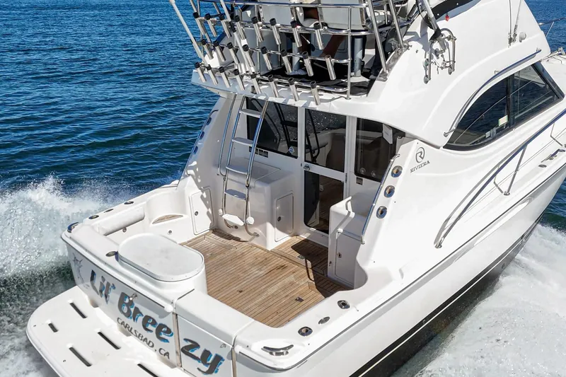 Slide: The Image of 2006 Riviera 33 Open Flybridge yacht cruising on blue ocean waters. - 4