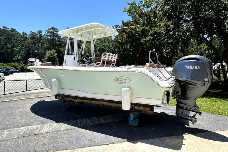 Slide: The Image of 2024 Sea Hunt Ultra 234 boat with Yamaha engine on display outdoors. - 1