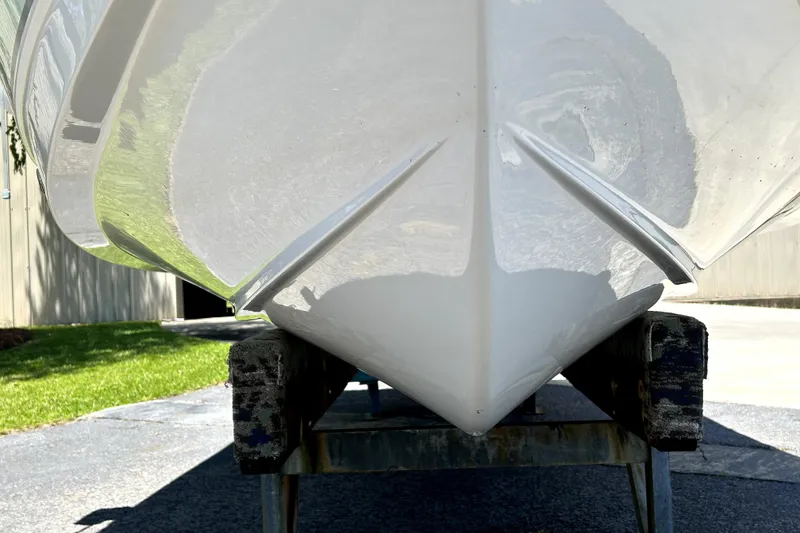 Slide: The Image of 2024 Sea Hunt Ultra 234 boat hull on trailer, showcasing sleek design and craftsmanship. - 4