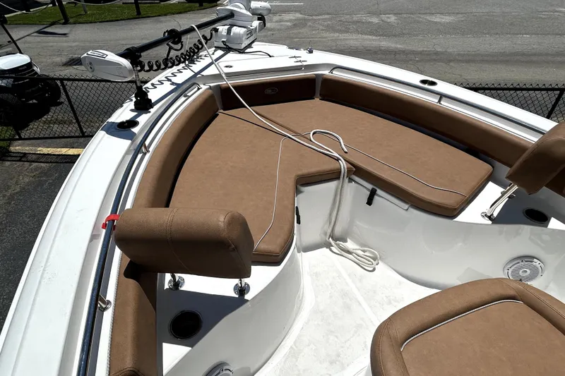 Slide: The Image of 2024 Sea Hunt Ultra 234 boat interior with brown seating and fishing equipment. - 5