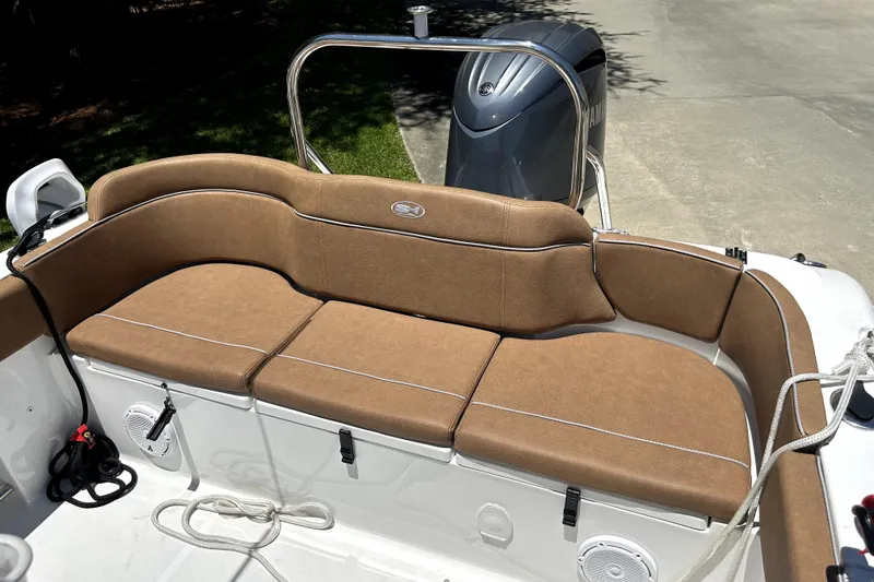 Slide: The Image of 2024 Sea Hunt Ultra 234 boat interior with tan seating and Yamaha engine. - 6