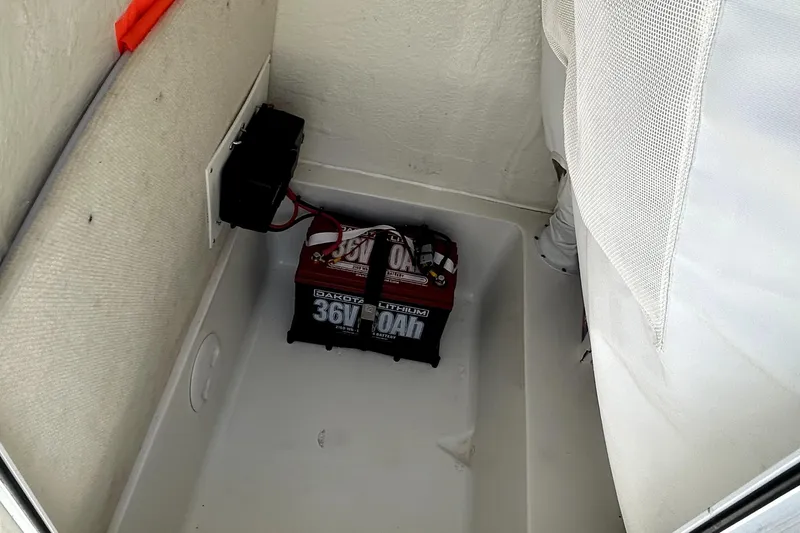 Slide: The Image of Battery compartment of 2024 Sea Hunt Ultra 234 boat with lithium battery installed. - 9