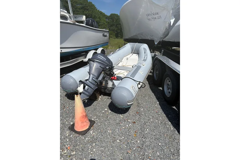 Slide: The Image of 2016 Zodiac Cadet RIB 340 PVC boat with Yamaha outboard motor on gravel. - 3