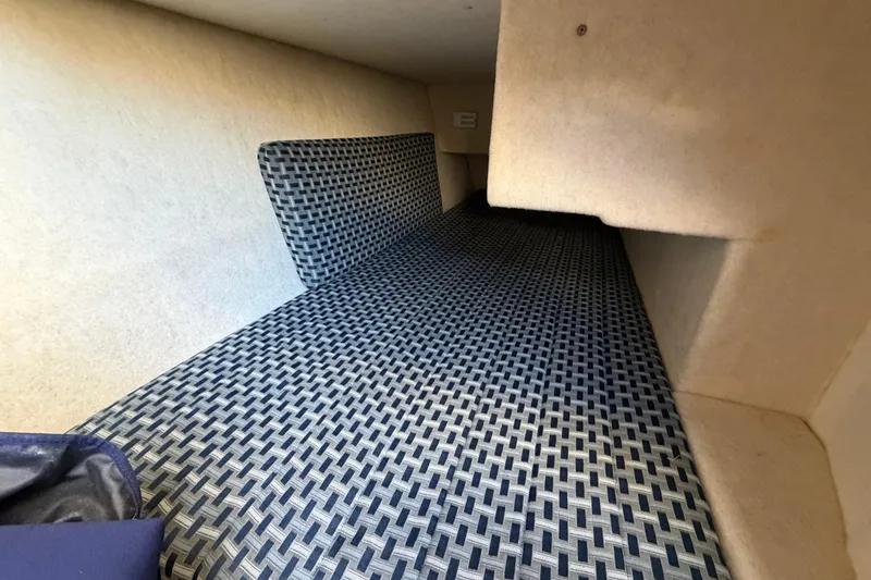Slide: The Image of 2005 Bayliner 288 Classic cabin interior with patterned bedding. - 11