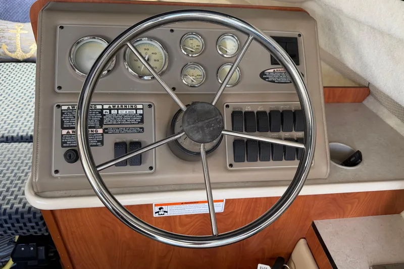 Slide: The Image of Steering wheel and dashboard of a 2005 Bayliner 288 Classic boat. - 9