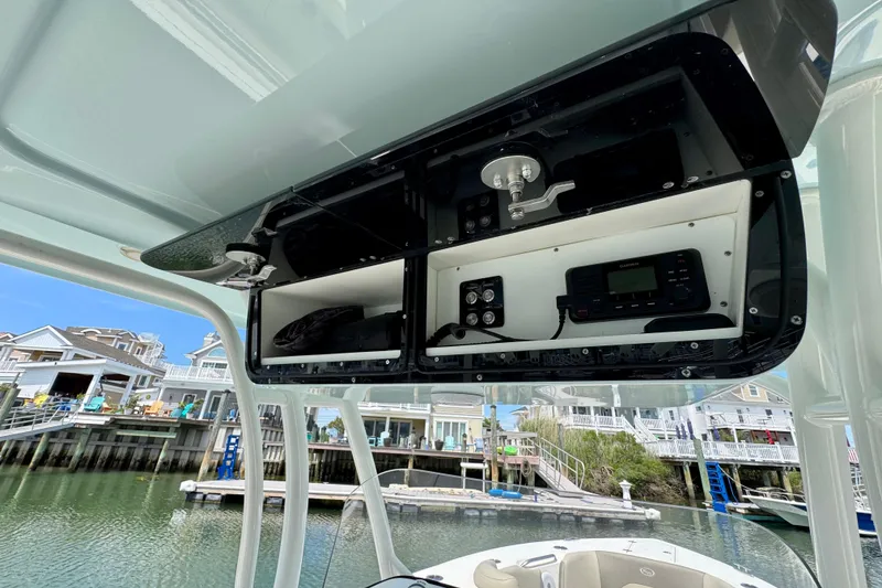 Slide: The Image of 2022 Key West 263 FS boat console with electronic controls and storage compartments. - 10