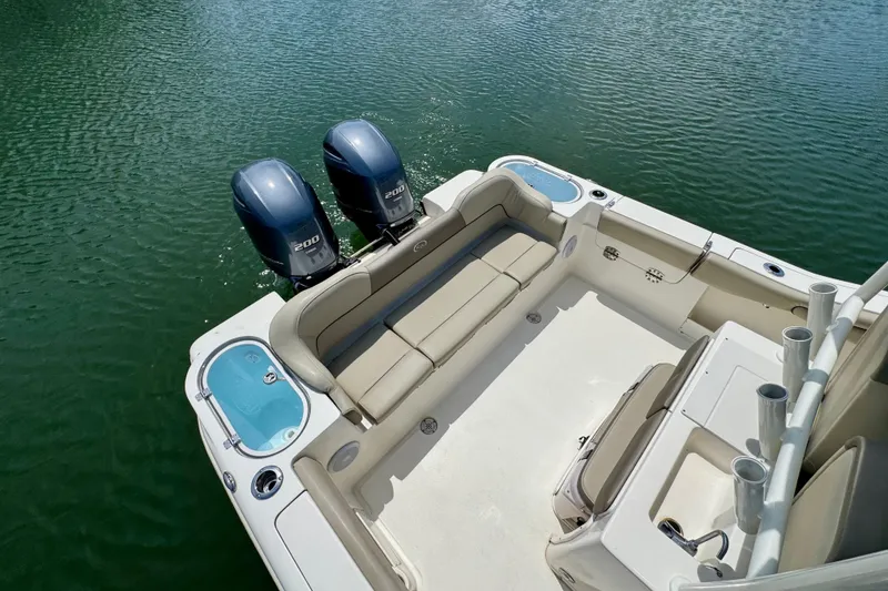 Slide: The Image of 2022 Key West 263 FS boat with dual engines and spacious seating on water. - 14