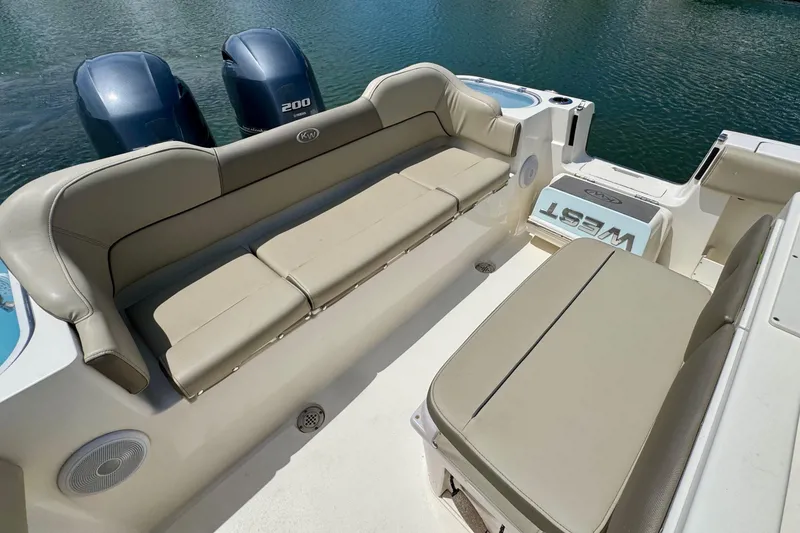 Slide: The Image of 2022 Key West 263 FS boat interior with beige seating and twin 200 engines. - 17