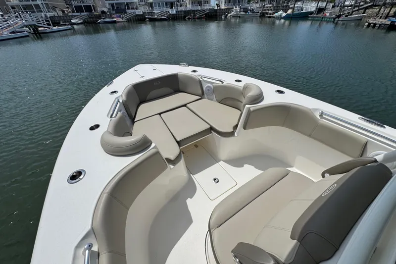 Slide: The Image of 2022 Key West 263 FS boat with spacious seating in a marina setting. - 19