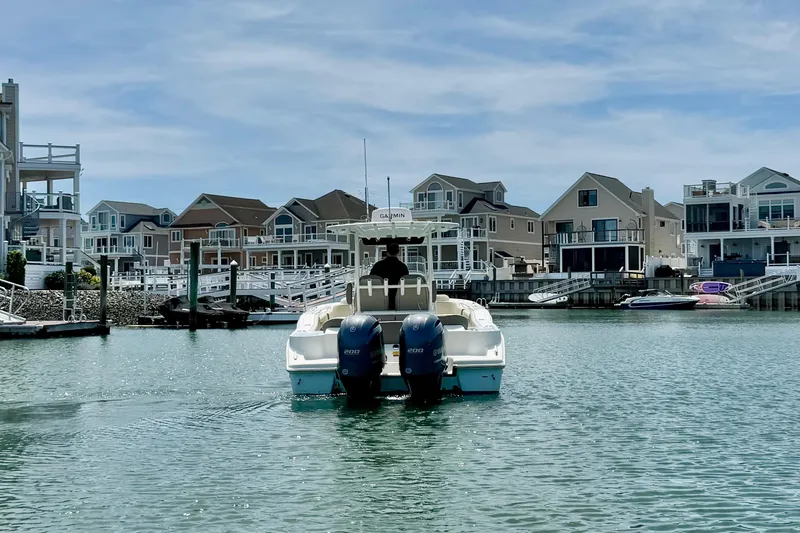 Slide: The Image of 2022 Key West 263 FS boat cruising in a scenic waterfront neighborhood. - 3