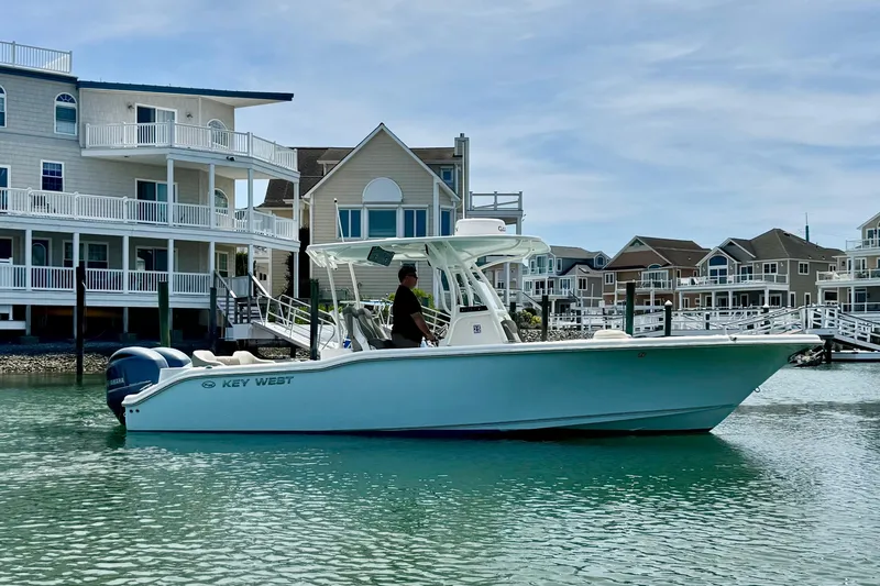 Slide: The Image of 2022 Key West 263 FS boat cruising near waterfront homes. - 5