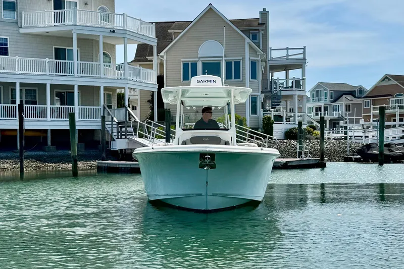 Slide: The Image of 2022 Key West 263 FS boat docked near waterfront homes. - 6
