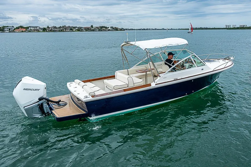 The Image of 2020 Hunt Yachts Harrier 26 cruising on calm waters with Mercury outboard engine. - 1