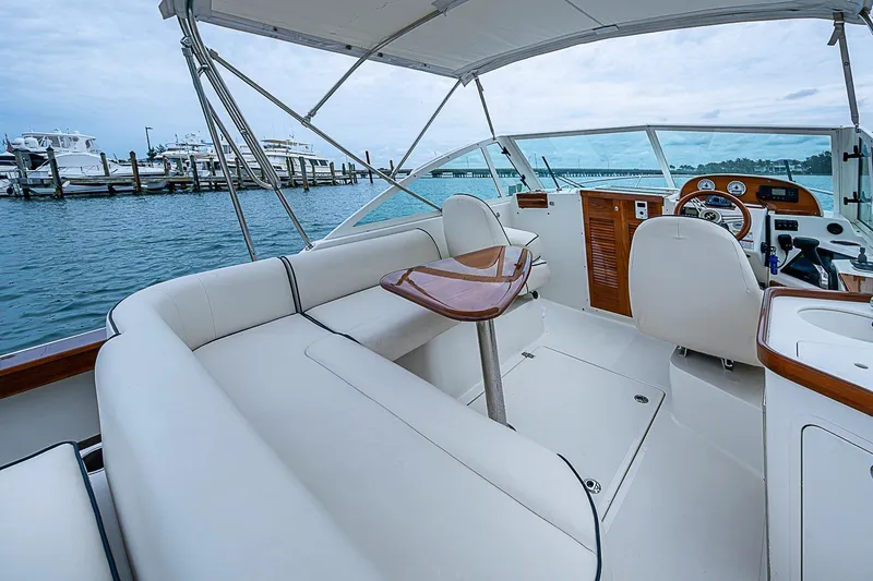 Slide: The Image of 2020 Hunt Yachts Harrier 26 interior with elegant seating and helm, docked at marina. - 18