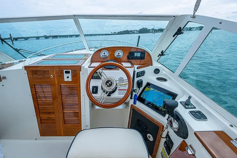 Slide: The Image of Cockpit of 2020 Hunt Yachts Harrier 26 with wooden accents and navigation equipment. - 23